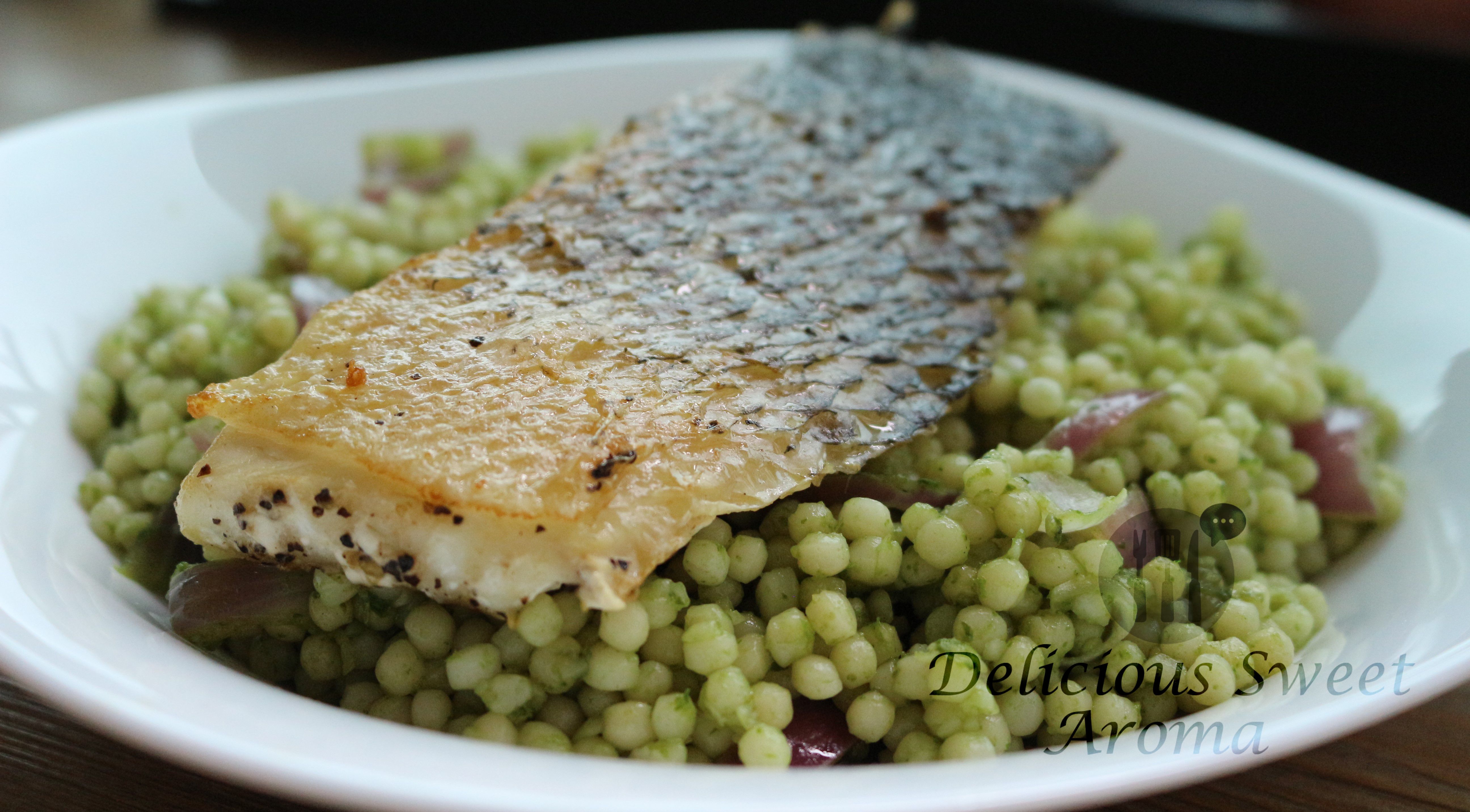 Israeli couscous mixed with parsley served with fish fillet